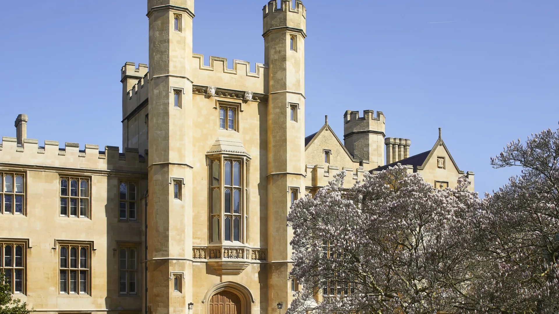 Lambeth palace exterior with magnolia tree to the right and blue skies.