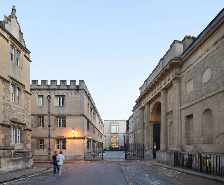 Corpus Christi College Oriel square with 2 people walking