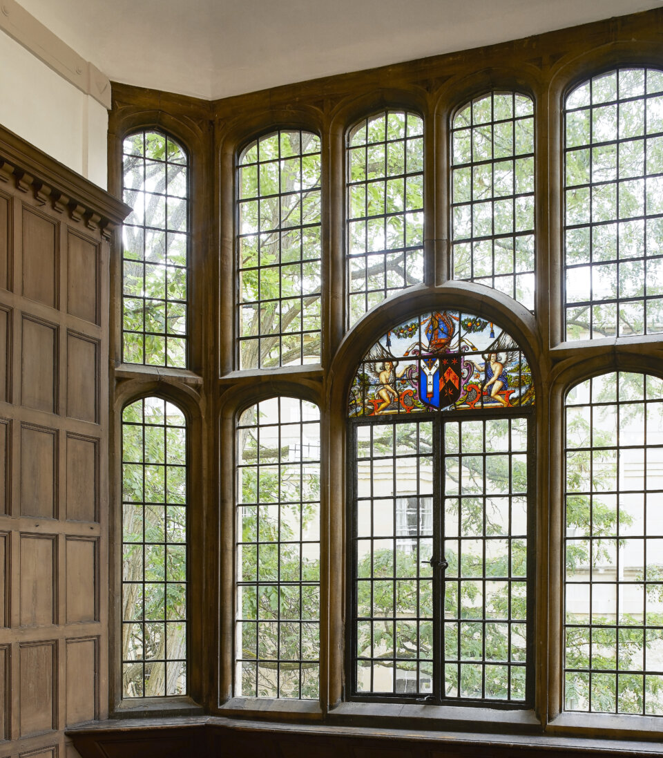 Historic stained glass windows and wooden panelled walls