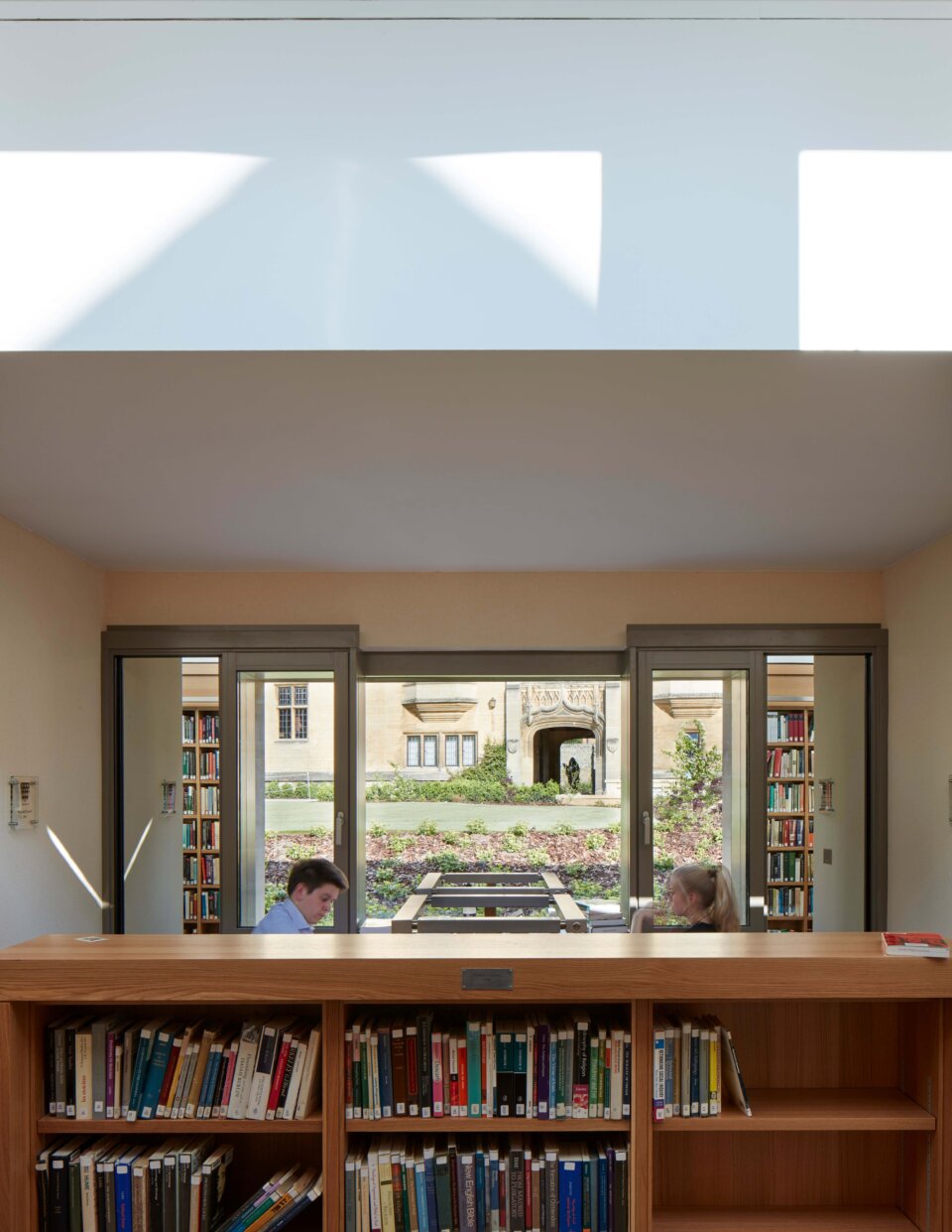 Readers space in Magdalen College Library looking out onto the garden beyond