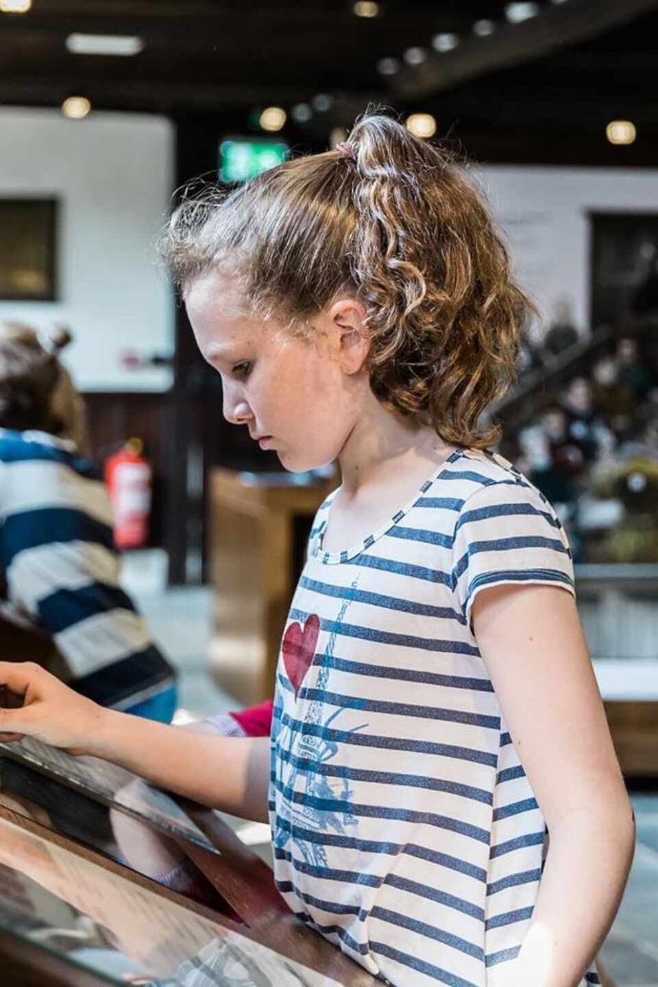 Girl using interactive screen at Shakespeare's School