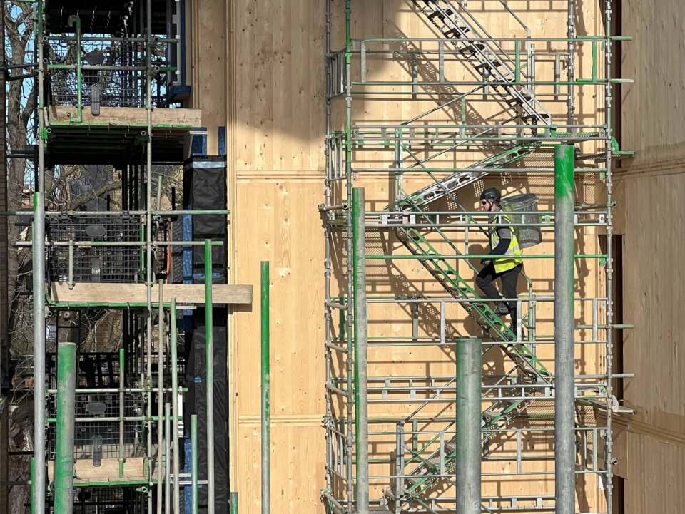 St Edmund Hall construction Image showing scaffolding and worker walking up stairs