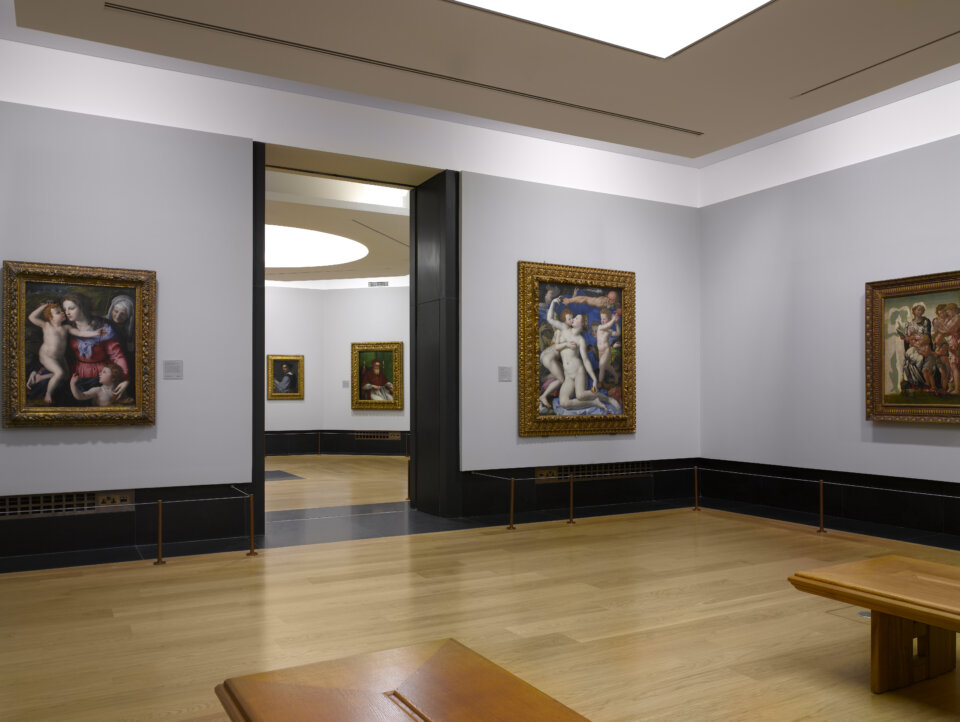 Interior of the lower galleries of the National Gallery in London designed by Wright & Wright with two benches and oil paintings in the room