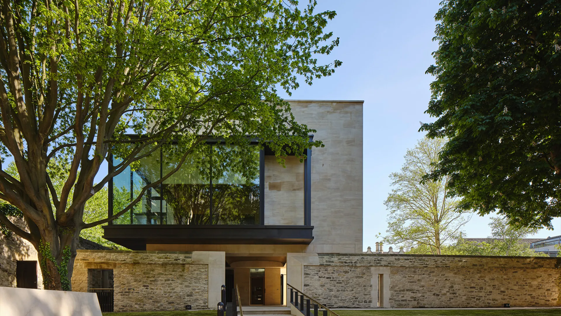 View of the St John's Library and Study Centre behind mature trees