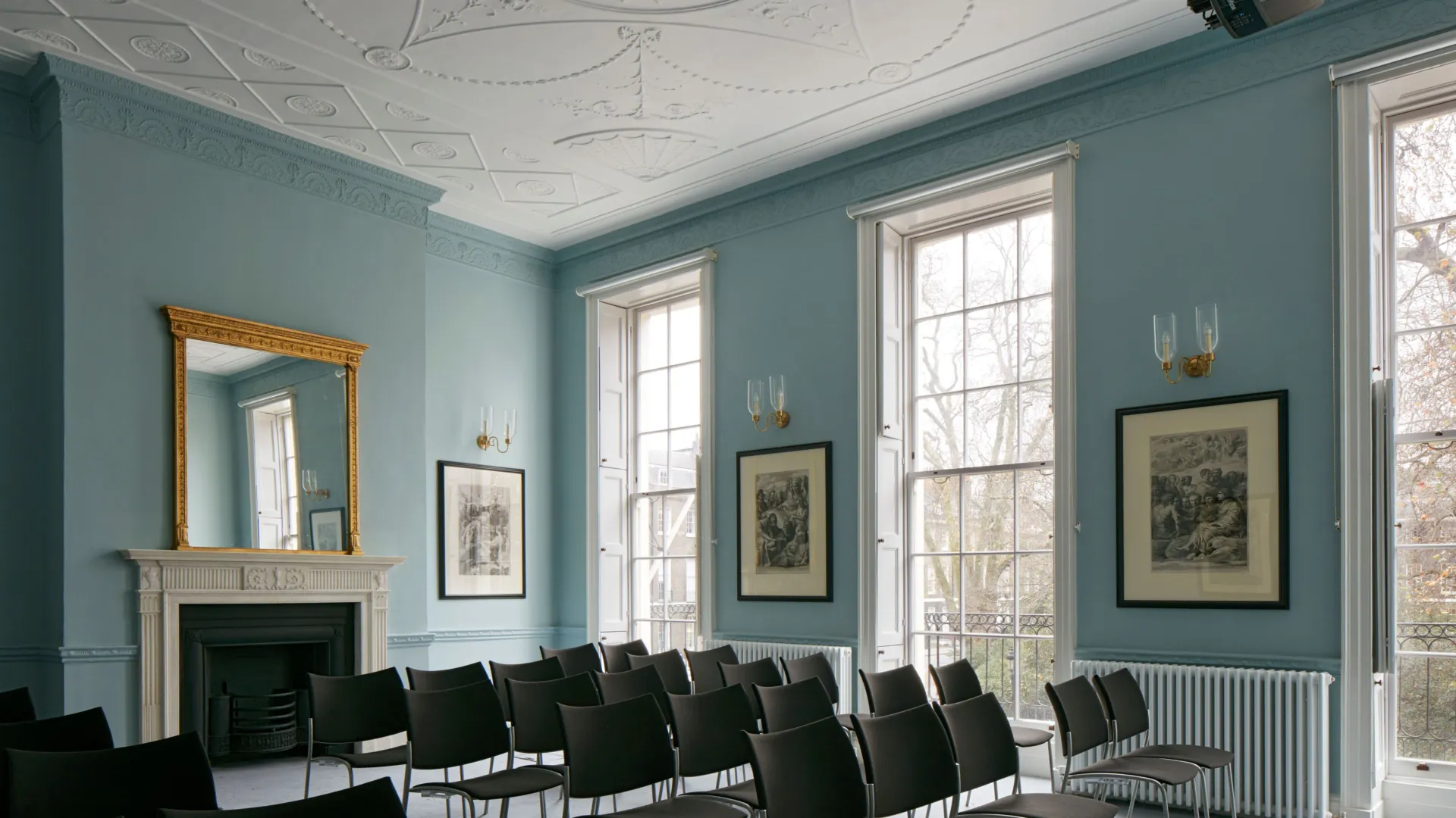 Seats arranged for a seminar in a historic room painted light blue in the Paul Mellon Centre for Studies in British Art in London