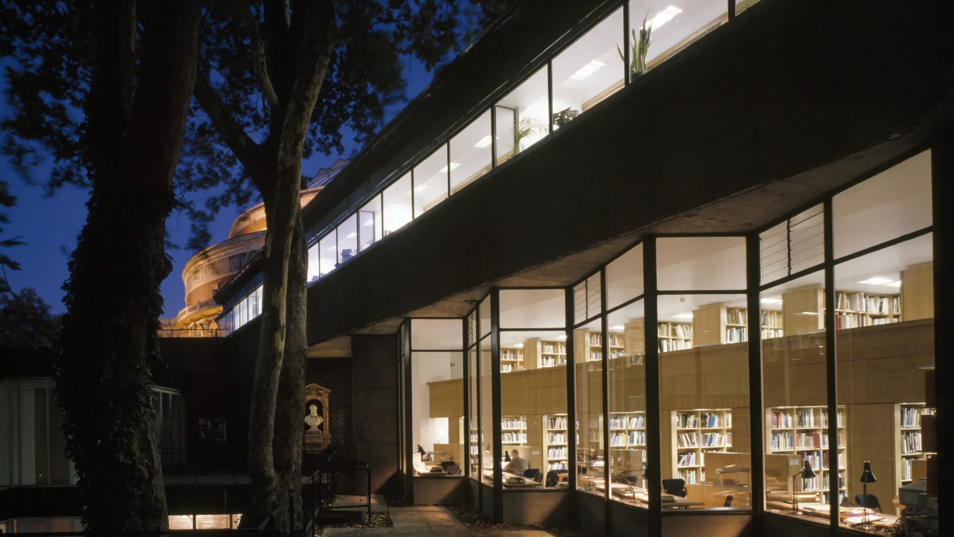 Night view of the glass facade exterior of the Royal College of Art Library in London