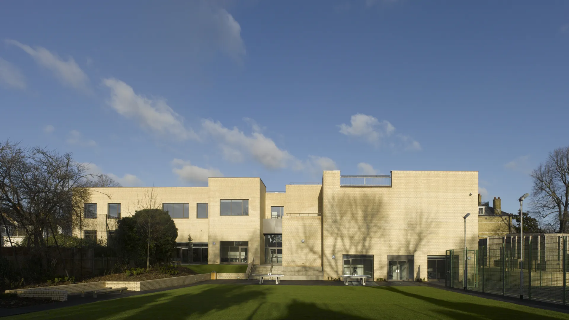 Exterior view of Newlands School with green lawn in foreground
