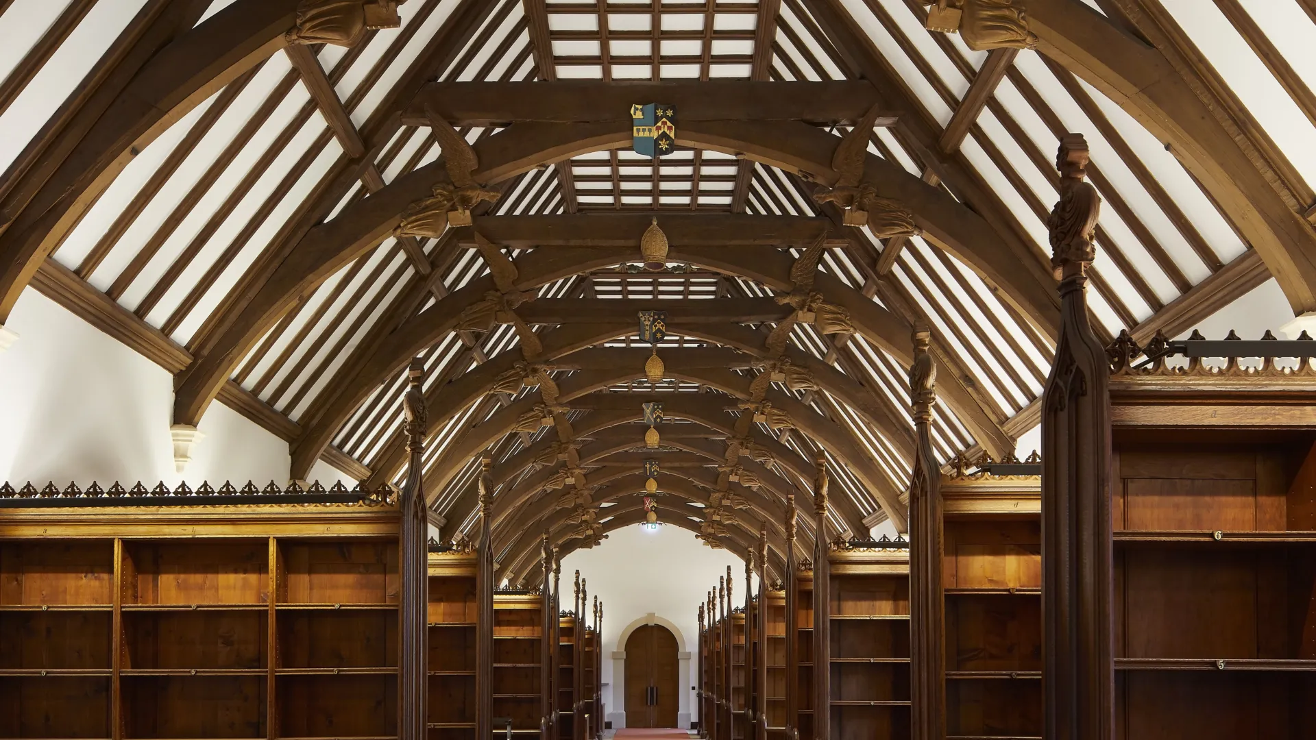 Image of a newly restored historic library with arched wooden beamed ceilings and bookshelves.
