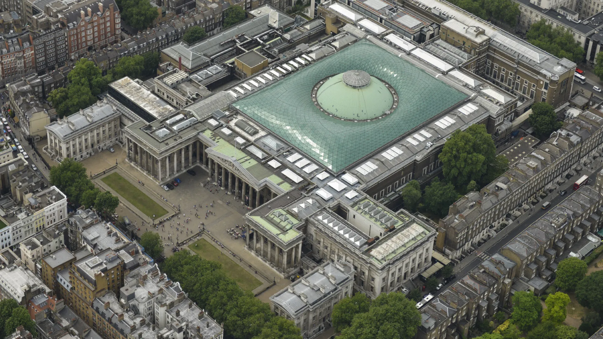 Aerial view of a museum with a large glass roof.