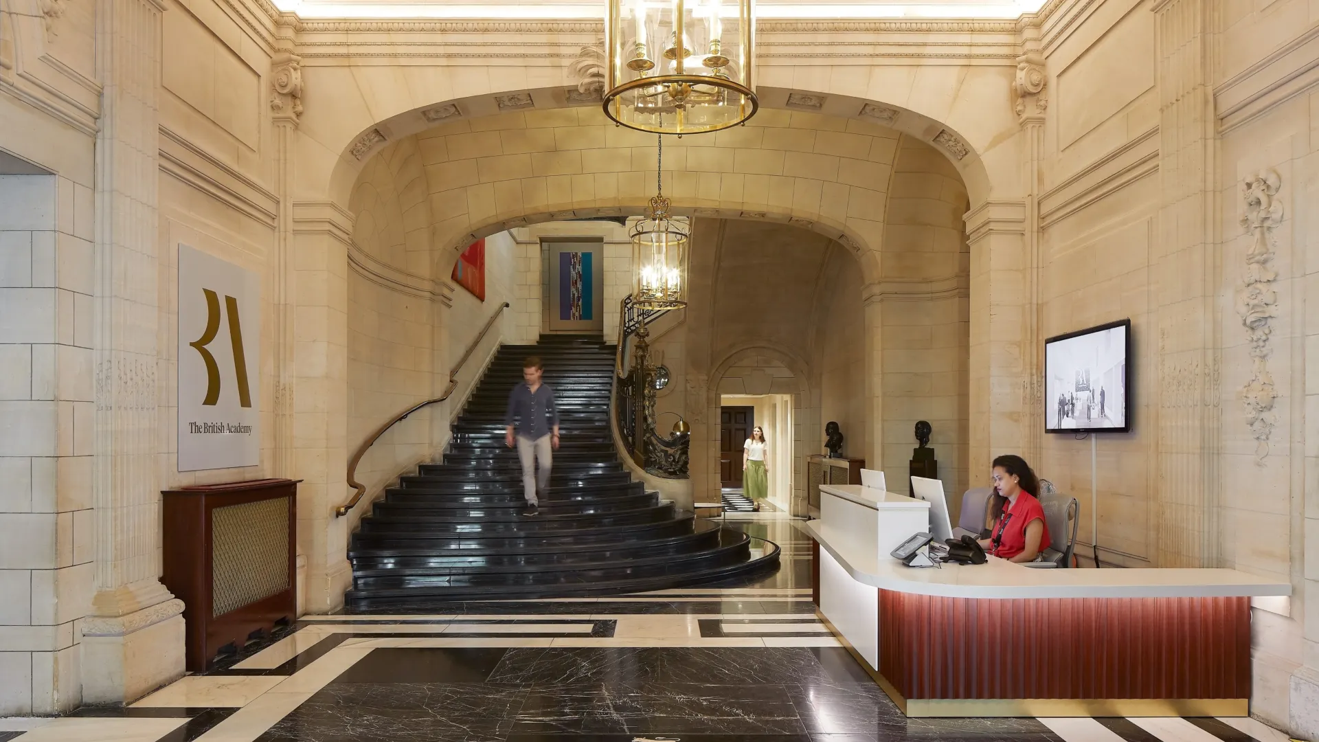 British Academy shot of the lobby by Hufton + Crow, there are 2 receptionists to the right.