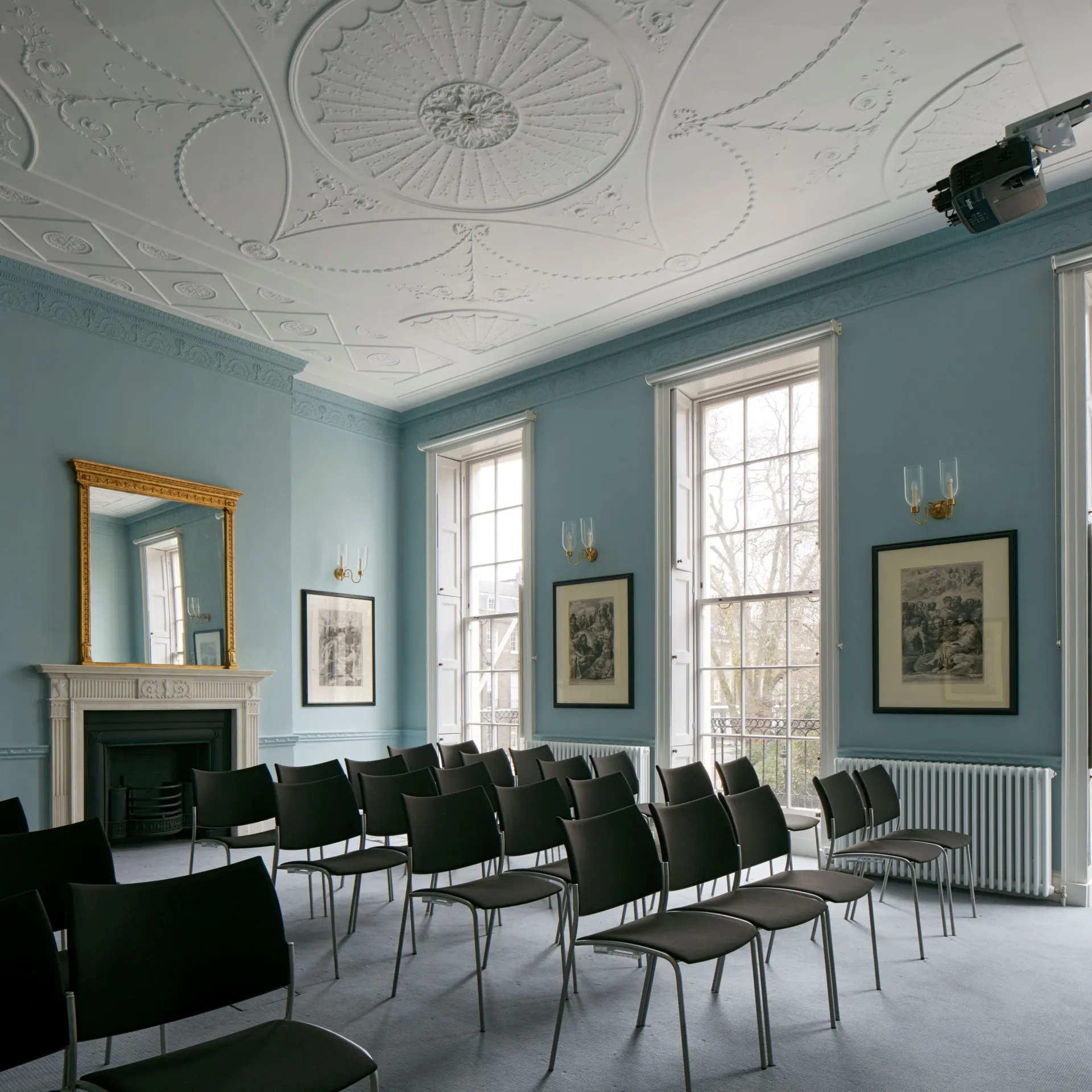 Seats arranged for a seminar in a historic room painted light blue in the Paul Mellon Centre for Studies in British Art in London