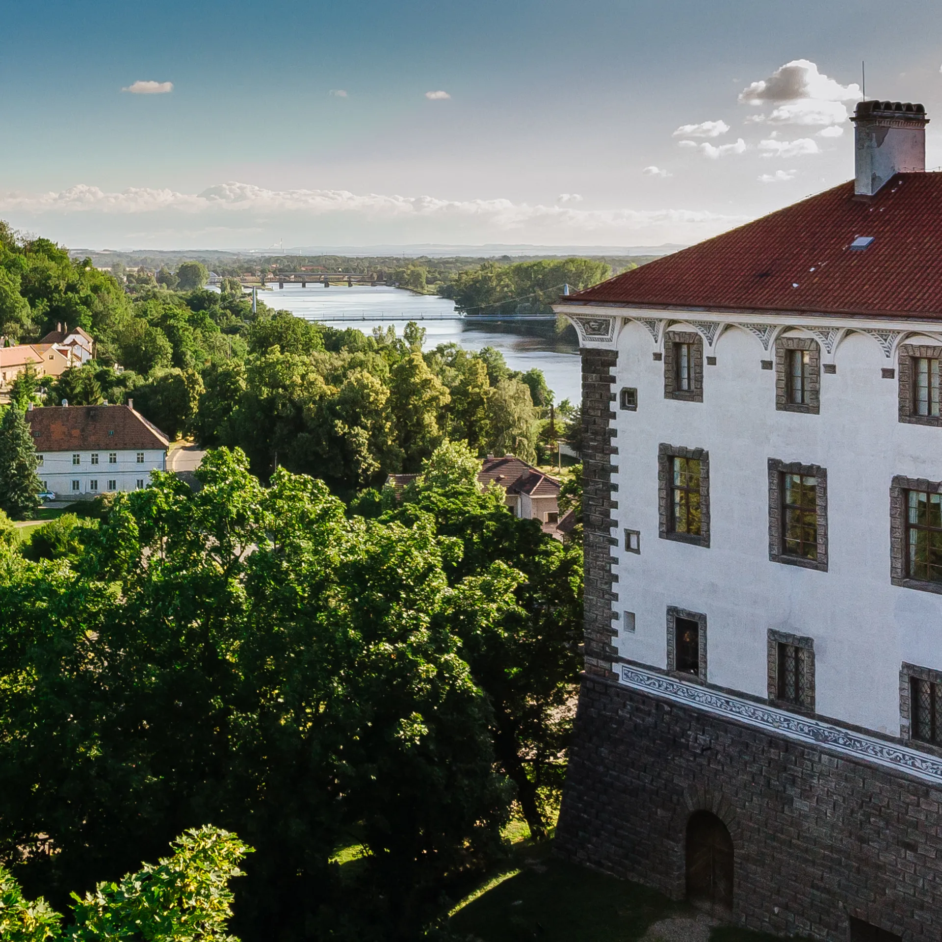 Aerial view of Nelahozeves Castle outside of Prague in the Czech Republic with view of the river and forests beyond the castle