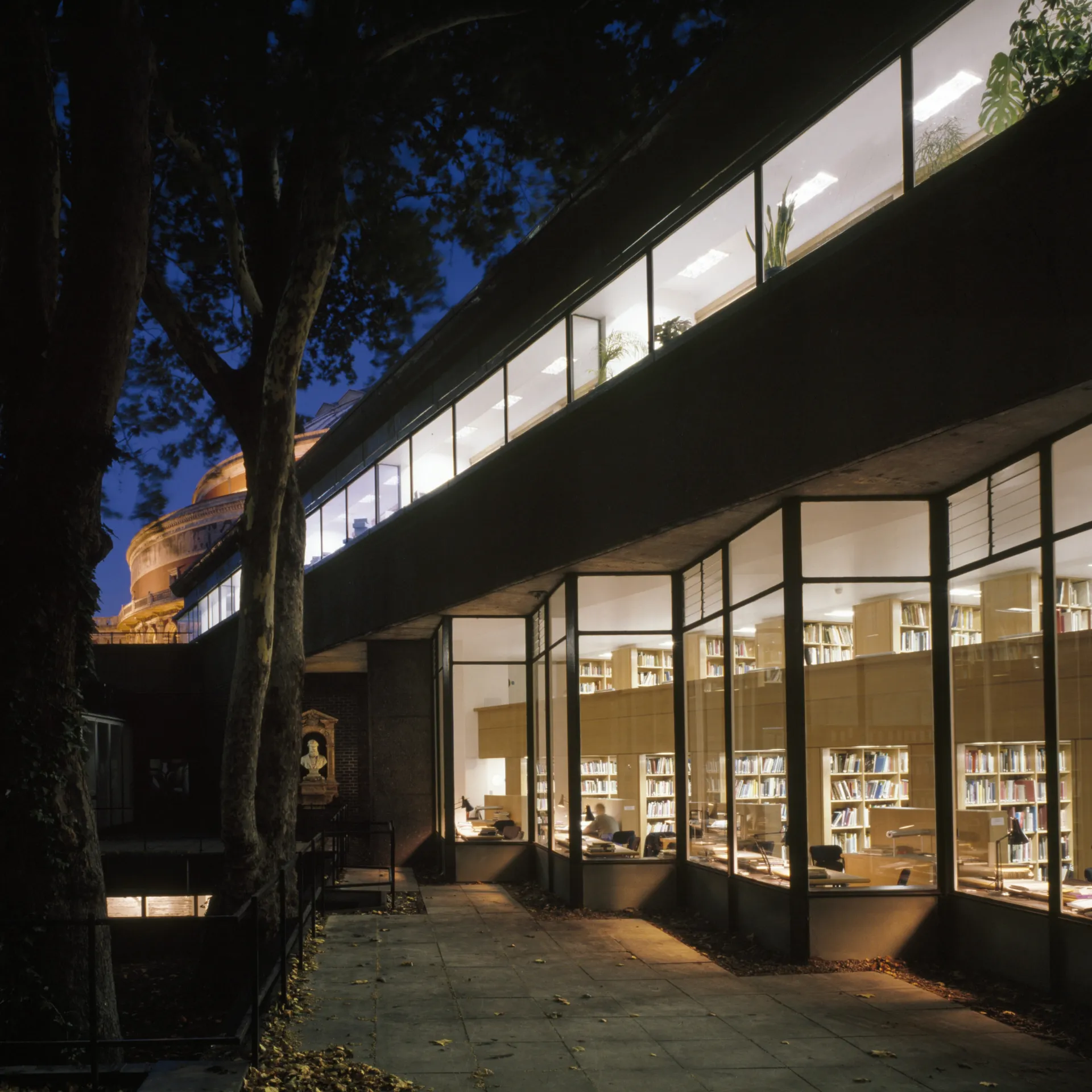 Night view of the glass facade exterior of the Royal College of Art Library in London