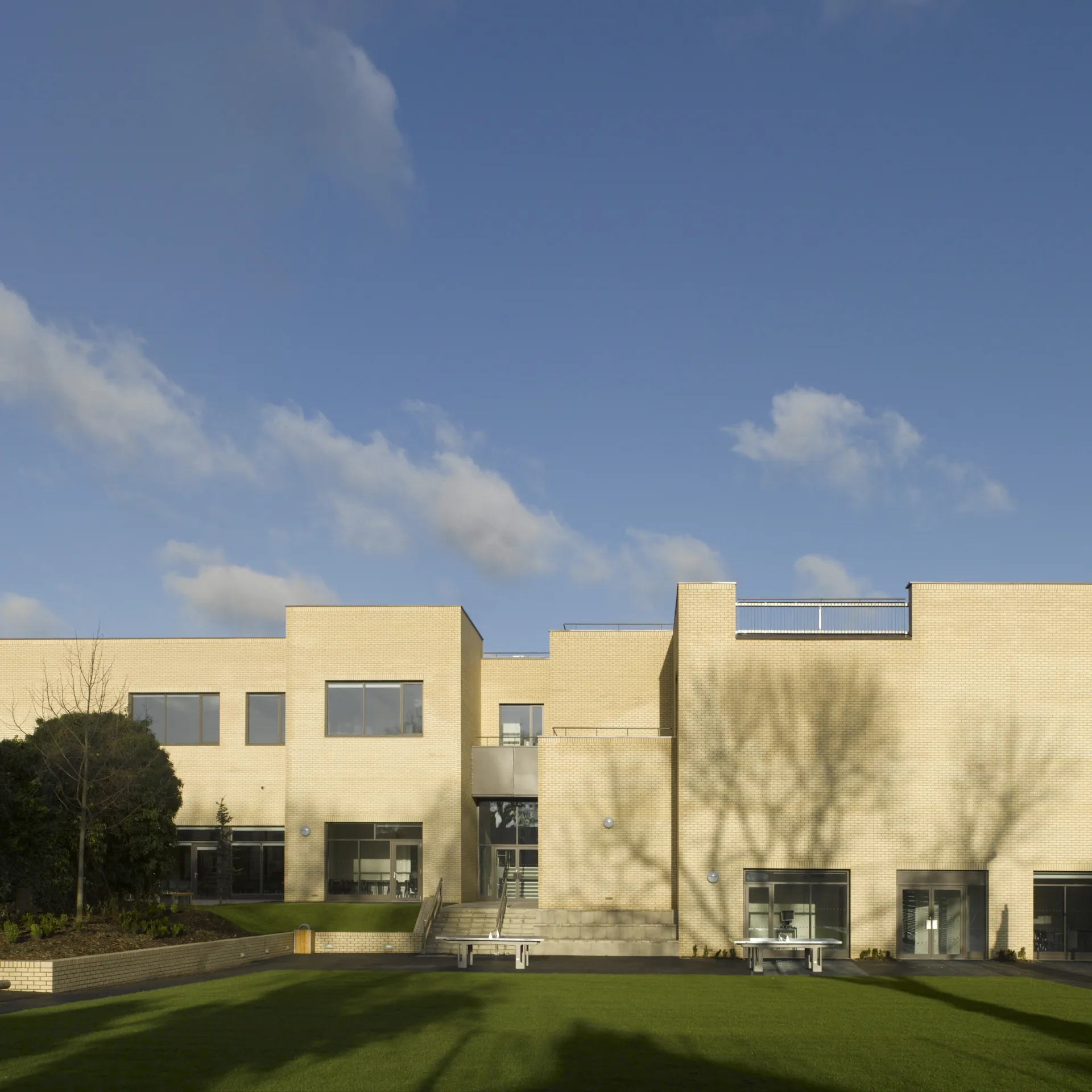 Exterior view of Newlands School with green lawn in foreground