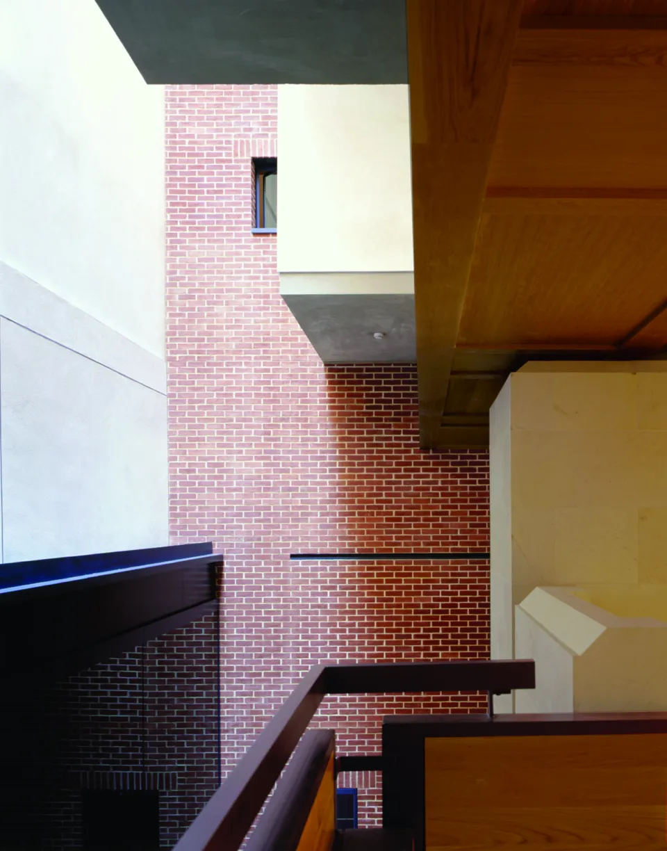 Interior of a staircase and double-height room made of brick in the Women's Library