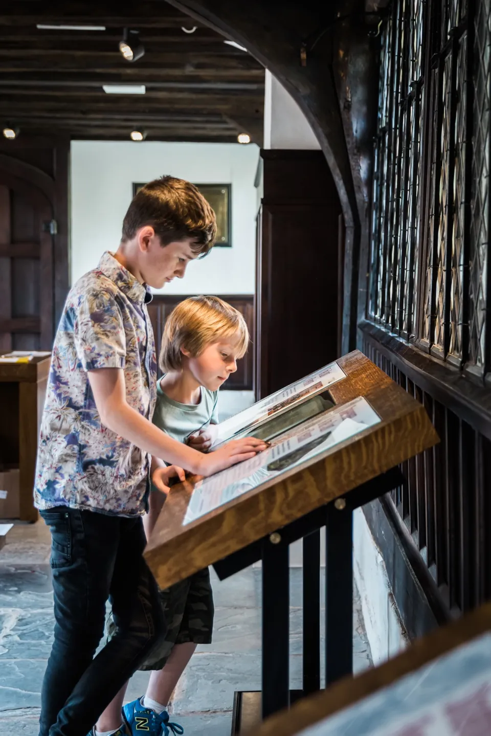 Visitors using interactive display at Shakespeare's Classroom