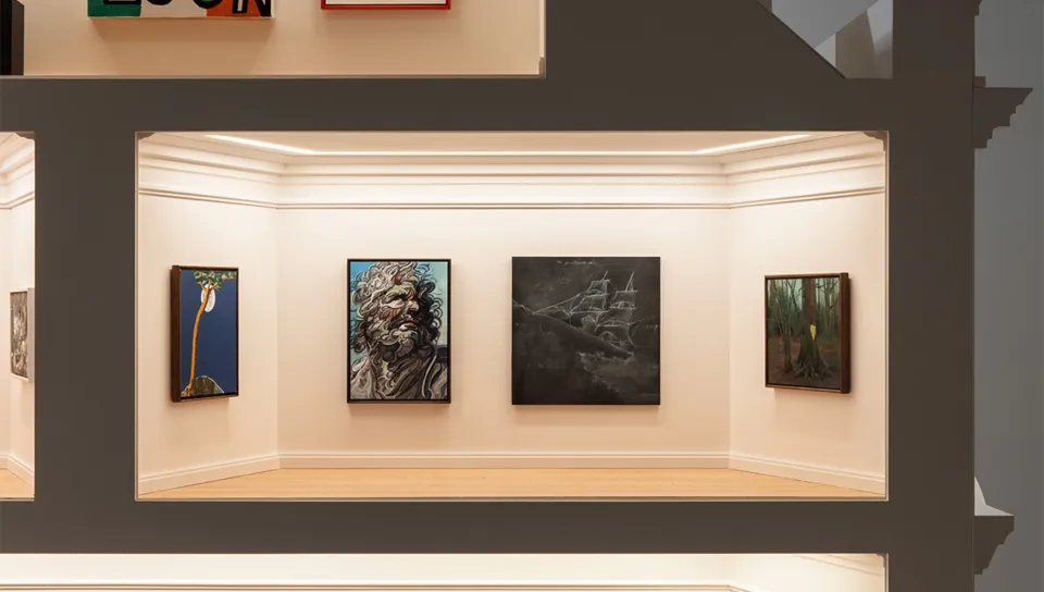 Photograph of the scale model interior, with artworks lining the far wall.