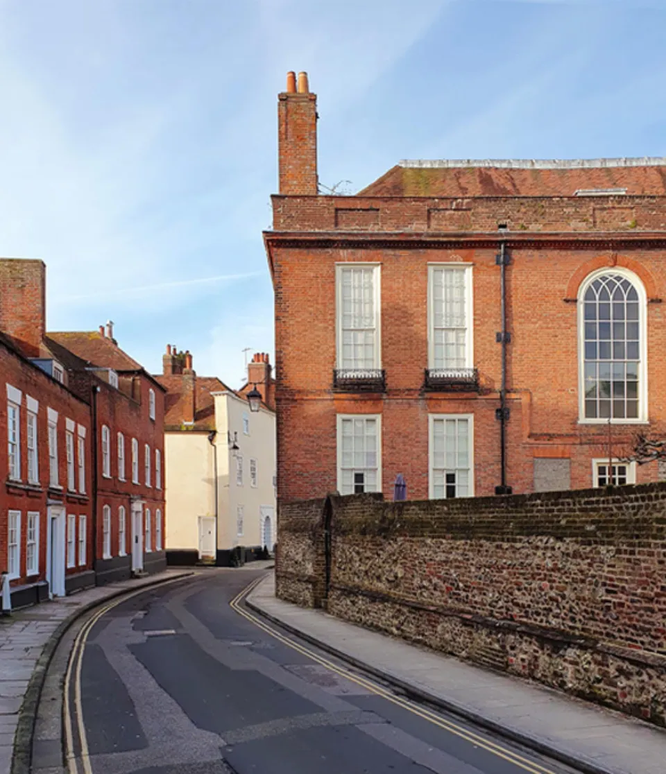 Photograph of Pallant House Gallery, a large red brick building with double height windows and brick chimney