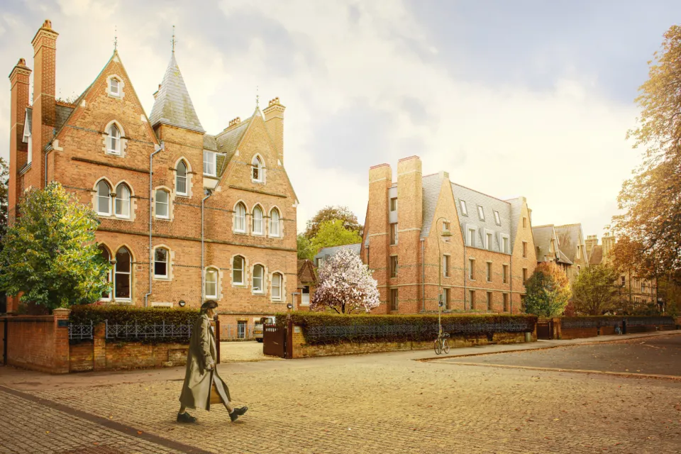 Architectural CGI rendering of a street with several Victorian and contemporary brick buildings along a paved road with a man walking from the left.