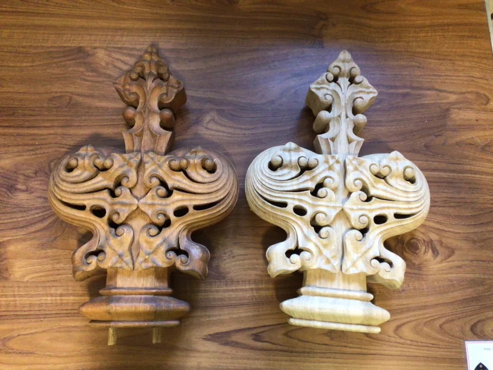 Two wooden finials on a wooden table