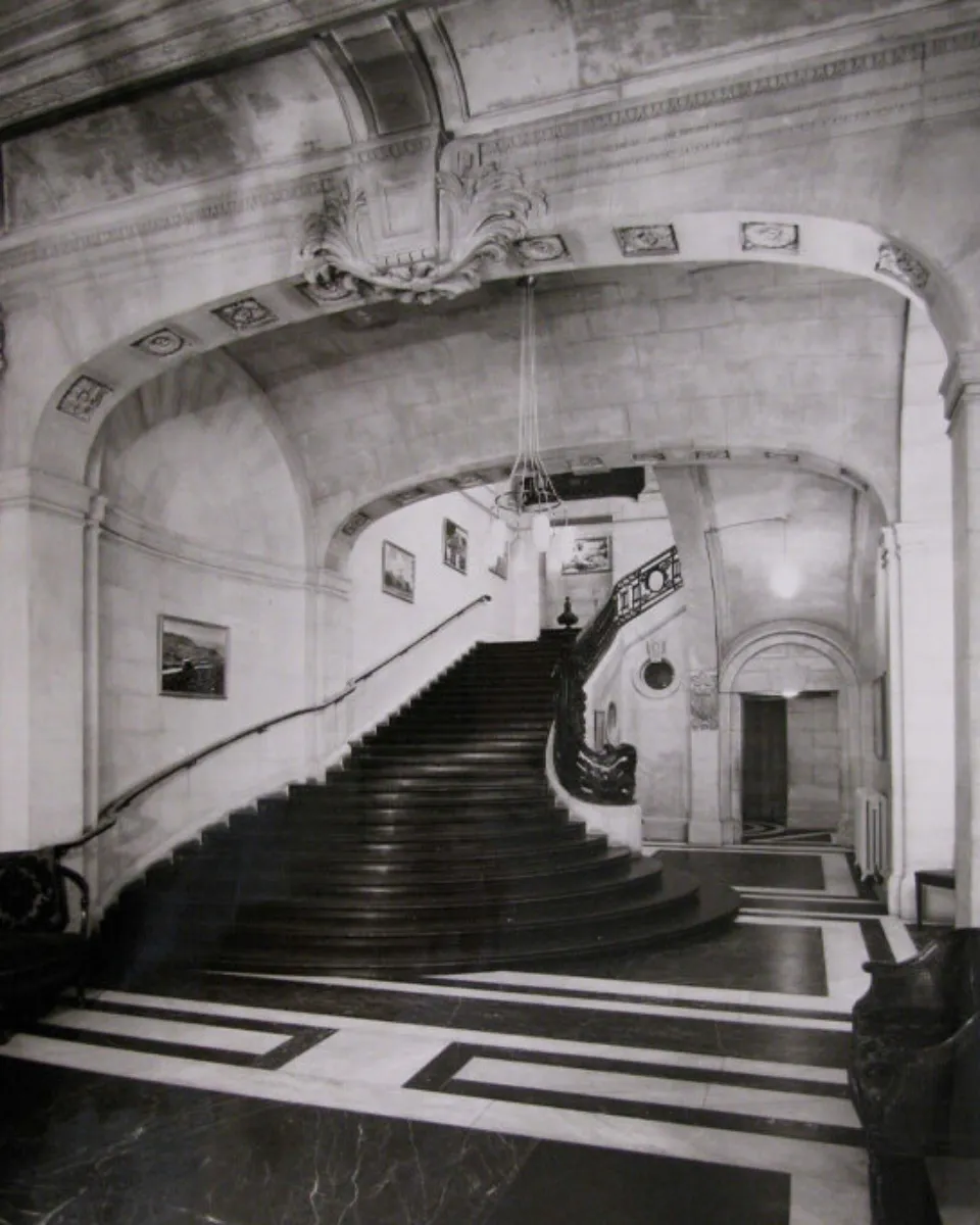 Black and white photographs of the foyer and grand staircase of the British Academy at Carlton House Terrace designed by John Nash in the 1830s.