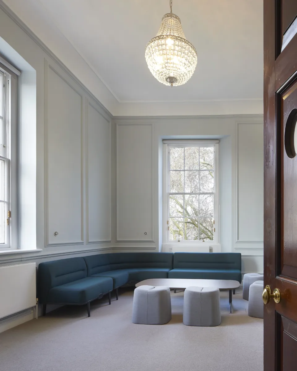 View through wooden door on to a shared working space in the British Academy designed by Wright & Wright Architects.