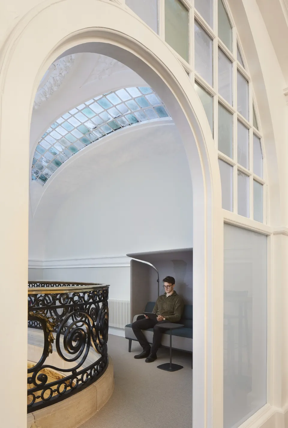 Man working on a bench in a shared office space inside the British Academy, designed by Wright & Wright.