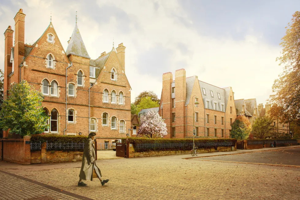 Architectural CGI rendering of a street with several Victorian and contemporary brick buildings along a paved road with a man walking from the left.