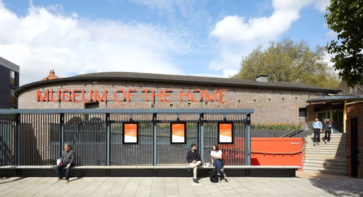 Entrance to Museum of the Home with people sitting on a bench in the foreground in Hackney London