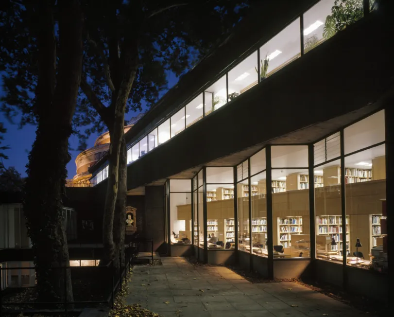 Night view of the glass facade exterior of the Royal College of Art Library in London