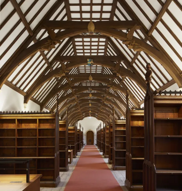 Image of a newly restored historic library with arched wooden beamed ceilings and bookshelves.