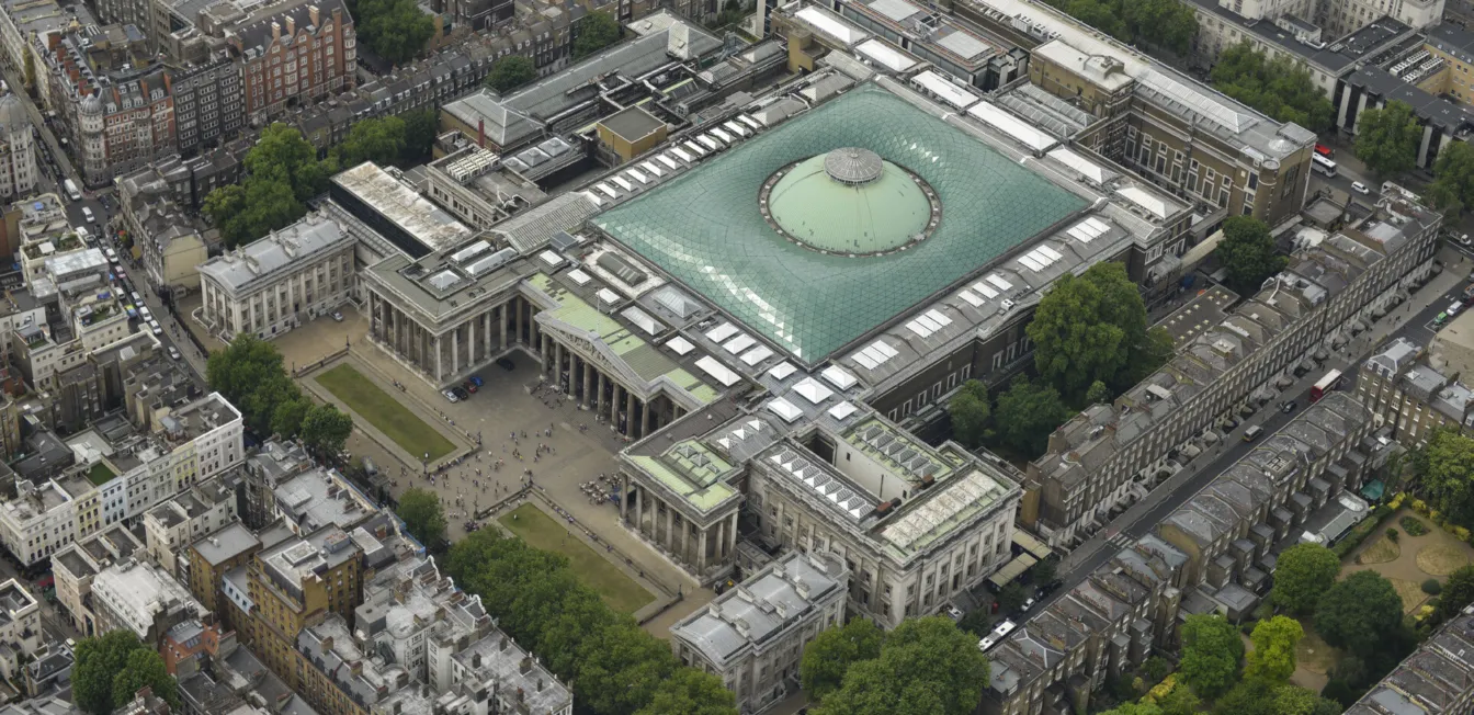 Aerial view of a museum with a large glass roof.