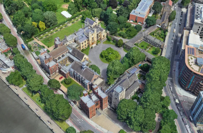 Aerial view of Lambeth Palace in London showing several brick and stone buildings and green spaces situated to the south of the River Thames