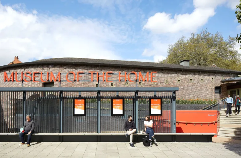 Entrance to Museum of the Home with people sitting on a bench in the foreground in Hackney London